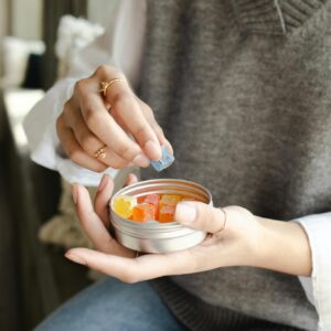 A Person Holding a Can of Gummy Candy