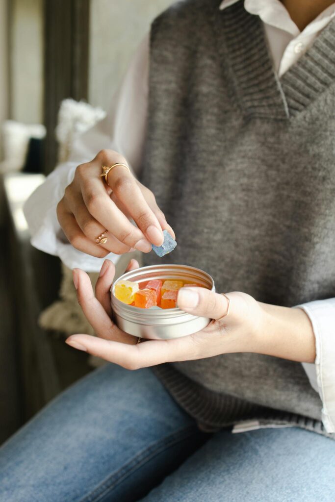 A Person Holding a Can of Gummy Candy