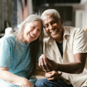 An Elderly Couple Sitting in the Living Room Holding a Cigarette